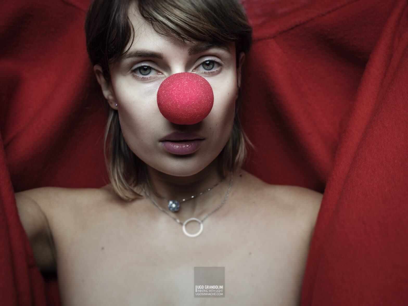 Nude woman with red clown nose
